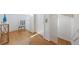 Light and airy hallway with hardwood floors and access to upper level at 108 Tern Dr, Anna Maria, FL 34216