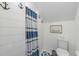 Simple bathroom with shower, toilet, and nautical decor at 108 Tern Dr, Anna Maria, FL 34216