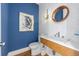 Stylish powder room with a floating vanity and blue walls at 108 Tern Dr, Anna Maria, FL 34216