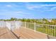 Spacious rooftop deck with white railings, offering scenic water views at 108 Tern Dr, Anna Maria, FL 34216