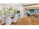 Charming dining area with a round table and white upholstered chairs at 108 Tern Dr, Anna Maria, FL 34216