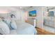 Main bedroom with a dresser, large TV, and en-suite bathroom access at 108 Tern Dr, Anna Maria, FL 34216