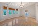 Spacious bedroom with hardwood floors, a chandelier, and access to a deck at 1910 Morris St, Sarasota, FL 34239