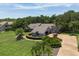 An aerial view of a landscaped single-Gathering home with mature trees and long driveway at 4714 Elder Berry Dr, Sarasota, FL 34241