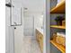 Bright bathroom featuring a sleek shower, wood vanity, and convenient built-in shelving for organized storage at 4714 Elder Berry Dr, Sarasota, FL 34241