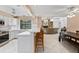 Open-concept kitchen with white cabinets, stainless steel appliances, and an eat-in bar at 4714 Elder Berry Dr, Sarasota, FL 34241