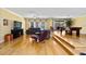 Spacious living room with hardwood floors, crown molding, pool table, and comfortable seating at 4714 Elder Berry Dr, Sarasota, FL 34241