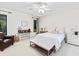 The main bedroom features neutral tones, a ceiling fan, a desk, and natural light at 4714 Elder Berry Dr, Sarasota, FL 34241