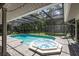 Refreshing screened pool and hot tub with ample patio space at 4714 Elder Berry Dr, Sarasota, FL 34241