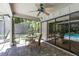 Covered patio with pool views, table and chairs, and ceiling fan at 4714 Elder Berry Dr, Sarasota, FL 34241