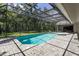 Large screened-in pool and hot tub with a spacious backyard at 4714 Elder Berry Dr, Sarasota, FL 34241