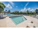 Inviting community pool and spa area with comfortable seating, lush landscaping, and beautiful water views at 111 Tidy Island Blvd # 111, Bradenton, FL 34210