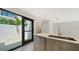 Modern kitchen with island, stainless steel appliances and access to a patio at 1558 4Th St # 210, Sarasota, FL 34236