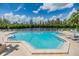 Community pool with plenty of lounge chairs and a relaxing atmosphere at 111 Tidy Island Blvd # 111, Bradenton, FL 34210