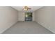Neutral living room featuring neutral carpeting and a sliding glass door with screened porch at 255 Sherwood Dr # 255U, Bradenton, FL 34210