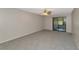 Comfortable living room with sliding glass doors and neutral colored carpet at 255 Sherwood Dr # 255U, Bradenton, FL 34210