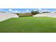 Large backyard with a grassy lawn and white fence at 335 Gris Sky Ln, Bradenton, FL 34212