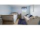 Light blue bedroom with crib and small couch at 335 Gris Sky Ln, Bradenton, FL 34212