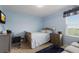 Blue bedroom with crib and a small couch at 335 Gris Sky Ln, Bradenton, FL 34212