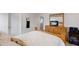 Bedroom with wooden dresser and a TV, offering comfortable space at 335 Gris Sky Ln, Bradenton, FL 34212