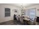 Bright dining room with chandelier and large wooden table, seating six at 335 Gris Sky Ln, Bradenton, FL 34212