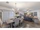 Open concept dining room flows into living room with hardwood floors and large windows at 335 Gris Sky Ln, Bradenton, FL 34212
