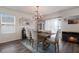 Elegant dining room features a rustic wood table and chandelier at 335 Gris Sky Ln, Bradenton, FL 34212