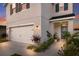 Two-story house with gray siding, white garage door, and landscaping at 335 Gris Sky Ln, Bradenton, FL 34212