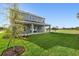 Spacious backyard with lush green grass, perfect for outdoor activities and relaxation at 7016 Foxboro Way, Nokomis, FL 34275
