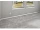 Bright bedroom with large windows and neutral carpet at 7016 Foxboro Way, Nokomis, FL 34275