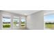 Bright bedroom with three windows offering backyard views at 7016 Foxboro Way, Nokomis, FL 34275