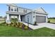 Charming two-story home with a well-manicured lawn and an attached two-car garage at 7016 Foxboro Way, Nokomis, FL 34275