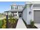 Inviting home entrance with well-maintained landscaping, a porch, and a walkway at 7016 Foxboro Way, Nokomis, FL 34275
