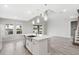 Spacious kitchen with island, farm sink, stainless steel appliances, and lots of natural light at 7016 Foxboro Way, Nokomis, FL 34275