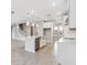 Open concept kitchen with island, stainless steel appliances, and a view of the staircase at 7016 Foxboro Way, Nokomis, FL 34275