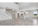 Large open-concept living space with a view of the kitchen, island, and a staircase at 7016 Foxboro Way, Nokomis, FL 34275