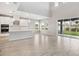 Bright, open-concept living space with a modern kitchen, and large sliding glass doors to the backyard at 7016 Foxboro Way, Nokomis, FL 34275