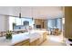Modern kitchen with island, white cabinetry, and city views at 625 S Palm Ave # 3C, Sarasota, FL 34236