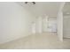 Open living room with tile floors and kitchen access at 4244 Central Sarasota Pkwy # 725, Sarasota, FL 34238