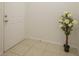 Simple entryway with tiled floor, white door and a decorative potted plant at 4244 Central Sarasota Pkwy # 725, Sarasota, FL 34238