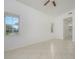 Spacious bedroom with tile floors, dual windows, and ceiling fan at 4244 Central Sarasota Pkwy # 725, Sarasota, FL 34238
