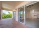 Private balcony with sliding glass doors and view of nature at 4244 Central Sarasota Pkwy # 725, Sarasota, FL 34238