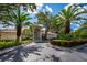 Community clubhouse entrance with palm trees at 4244 Central Sarasota Pkwy # 725, Sarasota, FL 34238