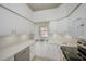 Modern kitchen featuring white cabinets, stainless steel appliances, and a window at 4244 Central Sarasota Pkwy # 725, Sarasota, FL 34238