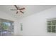Bright bedroom with tile floors, ceiling fan, and access to balcony at 4244 Central Sarasota Pkwy # 725, Sarasota, FL 34238