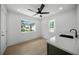 Modern wet bar with a quartz countertop and a dark sink at 2430 Floyd St, Sarasota, FL 34239