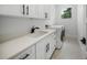 Clean laundry room with white cabinets and hexagon tile floor at 2446 Floyd St, Sarasota, FL 34239