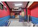 Large basement featuring red and blue walls and shelving and storage installation at 8607 51St W Ave, Bradenton, FL 34210