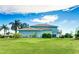 Beautiful teal two-story home with a well-manicured lawn and lots of palm trees at 8607 51St W Ave, Bradenton, FL 34210