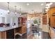 Eat-in kitchen featuring a central island, granite counters, modern appliances, and a bright breakfast nook at 8607 51St W Ave, Bradenton, FL 34210